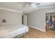 Neutral bedroom with wood-look flooring, a closet and modern light fixture at 7909 Fossil Creek Ln # 202, Las Vegas, NV 89145
