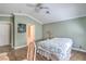 Comfortable bedroom with wood-look floors, light green walls, and a nearby bathroom at 7909 Fossil Creek Ln # 202, Las Vegas, NV 89145