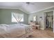 Bright bedroom featuring a window, closet and vanity with light-tone wood-look flooring at 7909 Fossil Creek Ln # 202, Las Vegas, NV 89145