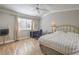 Relaxing bedroom with a view of the window, ceiling fan, and wood-look floors at 7909 Fossil Creek Ln # 202, Las Vegas, NV 89145