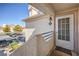 Exterior view of a condo front door with a welcoming 'Welcome' mat and ample parking nearby at 7909 Fossil Creek Ln # 202, Las Vegas, NV 89145