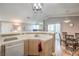 Well-lit kitchen with laminate flooring, a breakfast bar, seamlessly connects to the dining and living areas at 7909 Fossil Creek Ln # 202, Las Vegas, NV 89145