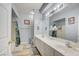 Bathroom with a double sink vanity, large mirror, and separate shower and bath at 833 Aspen Peak Loop # 712, Henderson, NV 89011