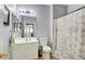 Bathroom with a white vanity, toilet, shower with a patterned curtain, and light fixture at 833 Aspen Peak Loop # 712, Henderson, NV 89011