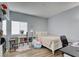 Well-lit bedroom with a white bed frame, storage shelves, and wood-look flooring at 833 Aspen Peak Loop # 712, Henderson, NV 89011