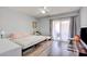 Bedroom with gray walls, wood-look flooring, a sliding glass door, and simple furnishings at 833 Aspen Peak Loop # 712, Henderson, NV 89011