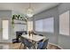 Cozy dining area with a stylish light fixture and ample natural light, adjacent to a living room with modern decor at 833 Aspen Peak Loop # 712, Henderson, NV 89011