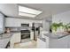Bright kitchen featuring stainless steel appliances, granite countertops, and modern white cabinets with an open layout at 833 Aspen Peak Loop # 712, Henderson, NV 89011