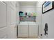 Functional laundry room featuring a washer, dryer, and overhead storage shelf at 833 Aspen Peak Loop # 712, Henderson, NV 89011