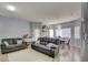 Bright living room features modern furnishings, wood-look floors, and plenty of space for relaxation and entertainment at 833 Aspen Peak Loop # 712, Henderson, NV 89011