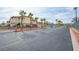 Wide shot of a parking lot surrounded by lush palm trees in a well-maintained community at 833 Aspen Peak Loop # 712, Henderson, NV 89011
