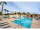 Enjoy this community pool with lounge chairs for relaxing on the pool deck and palm trees swaying in the breeze at 833 Aspen Peak Loop # 712, Henderson, NV 89011