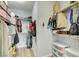 Spacious walk-in closet with shelving, hanging rods, and laminate flooring at 833 Aspen Peak Loop # 712, Henderson, NV 89011