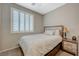 Cozy bedroom with shuttered window, wood accents and soft bedding at 8562 Insignia Ave # 102, Las Vegas, NV 89178