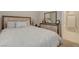 Comfortable bedroom with wood accents, soft bedding and lots of natural light at 8562 Insignia Ave # 102, Las Vegas, NV 89178