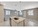 Open floor plan with oversized island, tile floors and lots of natural light at 8562 Insignia Ave # 102, Las Vegas, NV 89178