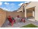 Inviting backyard with a fire pit area, comfortable chairs, and a well-maintained lawn, perfect for outdoor living at 8876 Trotternish Ridge Dr, Las Vegas, NV 89166