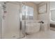 Bright bathroom featuring a modern shower and a luxurious soaking tub at 8876 Trotternish Ridge Dr, Las Vegas, NV 89166