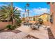 Landscaped backyard featuring a pool, spa, waterfall, and comfortable patio furniture at 8925 Rio Verde Ave, Las Vegas, NV 89147