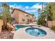Backyard showcasing a pool, spa, waterfall feature, and outdoor seating area at 8925 Rio Verde Ave, Las Vegas, NV 89147