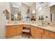 This luxurious bathroom features dual sinks, vanity, and lots of mirrors at 8925 Rio Verde Ave, Las Vegas, NV 89147