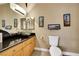 Bathroom featuring vessel sink with waterfall faucet and framed lighthouse artwork at 8925 Rio Verde Ave, Las Vegas, NV 89147