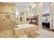This amazing bathroom has a sunken tub, glass shower, and fireplace at 8925 Rio Verde Ave, Las Vegas, NV 89147