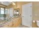 Bathroom with tiled countertops, double sinks, and a glass-enclosed shower at 8925 Rio Verde Ave, Las Vegas, NV 89147