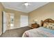 This inviting bedroom has an attached bath, neutral walls, plush carpet, ceiling fan, and closet at 8925 Rio Verde Ave, Las Vegas, NV 89147