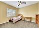 Bedroom with carpet, shutters, ceiling fan, and minimal furnishings at 8925 Rio Verde Ave, Las Vegas, NV 89147
