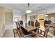 Elegant dining room with a grand table and views into the living room at 8925 Rio Verde Ave, Las Vegas, NV 89147
