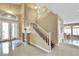 Inviting foyer with staircase, decorative columns, and tiled flooring at 8925 Rio Verde Ave, Las Vegas, NV 89147