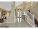Bright foyer with a staircase, double doors, and glossy tiled floor at 8925 Rio Verde Ave, Las Vegas, NV 89147
