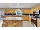 Modern kitchen with island, granite countertops, and stainless steel appliances at 8925 Rio Verde Ave, Las Vegas, NV 89147
