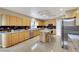 Open concept kitchen with granite counters, center island, and tile floors at 8925 Rio Verde Ave, Las Vegas, NV 89147