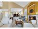 Open-concept living room with fireplace, and seamless flow to dining area at 8925 Rio Verde Ave, Las Vegas, NV 89147
