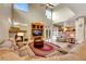 Inviting living room featuring a fireplace, large windows, and comfortable seating at 8925 Rio Verde Ave, Las Vegas, NV 89147
