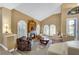 Cozy living room with fireplace, vaulted ceiling, and natural light at 8925 Rio Verde Ave, Las Vegas, NV 89147