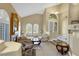 Spacious living room features a fireplace, high ceilings, and arched windows at 8925 Rio Verde Ave, Las Vegas, NV 89147