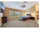 Spacious main bedroom with high ceilings, plantation shutters, ceiling fan, and plush carpet at 8925 Rio Verde Ave, Las Vegas, NV 89147