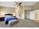 This expansive main bedroom features a fireplace, ensuite bathroom, neutral walls, and plush carpet at 8925 Rio Verde Ave, Las Vegas, NV 89147