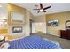 This incredible main bedroom has a fireplace, television, ensuite bathroom, neutral walls, and plush carpet at 8925 Rio Verde Ave, Las Vegas, NV 89147