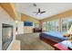 This expansive main bedroom has an ensuite bathroom, fireplace, television, plantation shutters, and plush carpet at 8925 Rio Verde Ave, Las Vegas, NV 89147