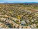 Aerial view of a residential area including a gold course with many homes and buildings at 9616 Grand Isle Ln, Las Vegas, NV 89144