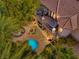 Stunning aerial view of a backyard with a pool, lounge area, and lush greenery at 9616 Grand Isle Ln, Las Vegas, NV 89144