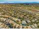 Aerial view of a residential area with many homes, lawns, and a golf course nearby at 9616 Grand Isle Ln, Las Vegas, NV 89144