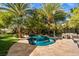 Lush backyard oasis with a beautiful pool, spa, and mature landscaping at 9616 Grand Isle Ln, Las Vegas, NV 89144