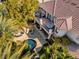 Aerial view of backyard featuring pool, lounge chairs and covered deck with outdoor seating area at 9616 Grand Isle Ln, Las Vegas, NV 89144