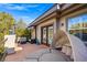 Serene balcony area with a unique daybed, dark metal canopy, and elegant wrought iron railing at 9616 Grand Isle Ln, Las Vegas, NV 89144