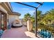 Relaxing covered balcony with comfortable seating, decorative railing, and lush green trees at 9616 Grand Isle Ln, Las Vegas, NV 89144